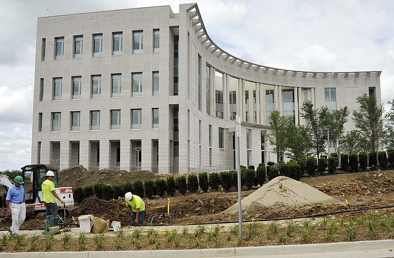 
From left, Tom Horn, Geno Martinez and Chris Luebbering work on installing the irrigation system Wednesday at the new Federal Courthouse. Missouri Senators are proposing that the courthouse be named after former senator and Gov. Kit Bond, who was a proponent of the construction.