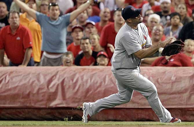 St. Louis Cardinals first baseman Albert Pujols keeps the ball in his glove after catching a pop foul hit by Cincinnati Reds' Jonny Gomes in the seventh inning of a baseball game, Saturday, July 16, 2011, in Cincinnati. St. Louis won 4-1. 