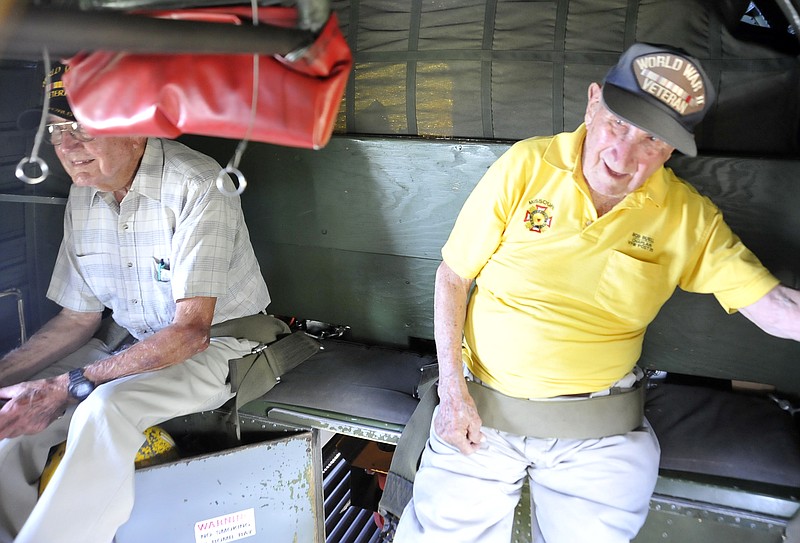 Former WWII airman Wilburn Rowden, left, and Bob Buell look out the windows of a B-24 Liberator Monday as it flys over Jefferson City. The plane along with a North American P-51 Mustang and a Boeing B-17 Flying Fortress will be hosting tours and rides of the historic aircraft until noon Wednesday.