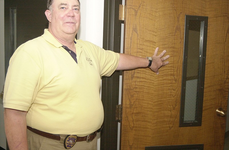 Fulton Police Chief Steve Myers leads the way into one of the offices at the old Callaway Electric Cooperative. The city finalized a contract Friday to purchase the building with the intent of relocating the Fulton Police Department.                                                              