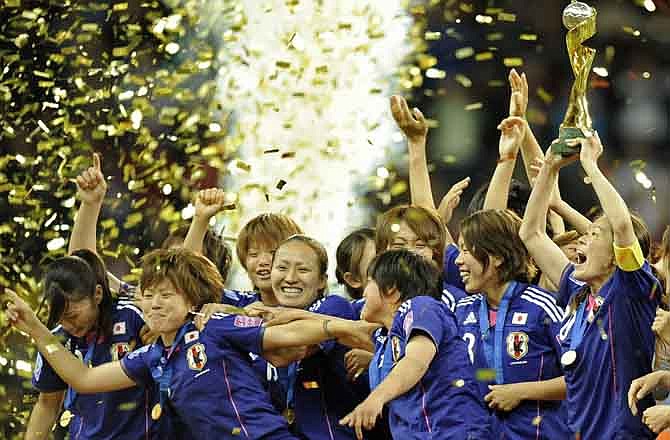 Japan players celebrate with the trophy following the final match between Japan and the United States at the Women's Soccer World Cup in Frankfurt, Germany, Sunday, July 17, 2011.
