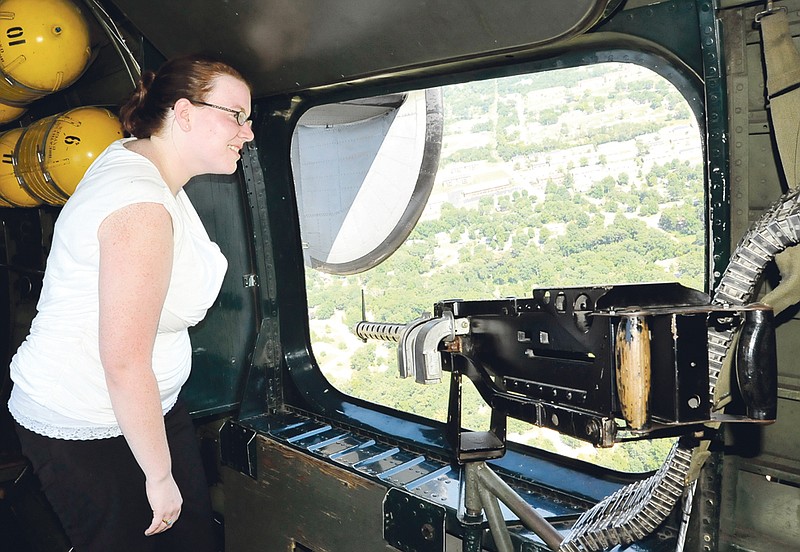 Reporter Madeleine Leroux takes in the view from a World War II bomber - a Consolidated B-24J Liberator - Monday as part of the Wings of Freedom Tour.
