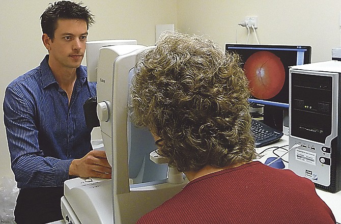 In this undated photo provided by CSIRO Australia, researcher Shaun Frost of CSIRO Australia, that nation's science agency, photographs a woman's retina as part of a research project into early detection of Alzheimer's disease. 