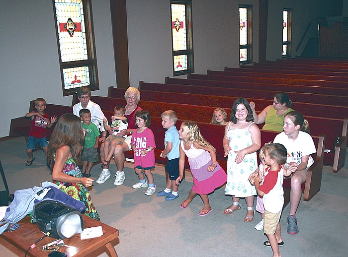 Children in the preschool and kindergarten class at St. Paul's Lutheran Vacation Bible School July 11-15 learn a new song in Music class Thursday, July 14, instructed by Kassi Meisenheimer, seated facing the children, at left.