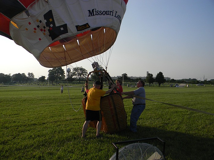 KRCG Reporter Teresa Snow hops into the hot air balloon before it takes off during the California Balloon Invitational Media Flight held Friday, July 15, at Windmill Ridge.