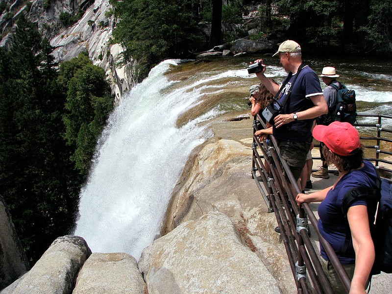 Tourists visit the top of Vernal Falls in Yosemite National Park in July 2010. Three visitors were presumed dead Wednesday after being swept over the raging waterfall, authorities said. 