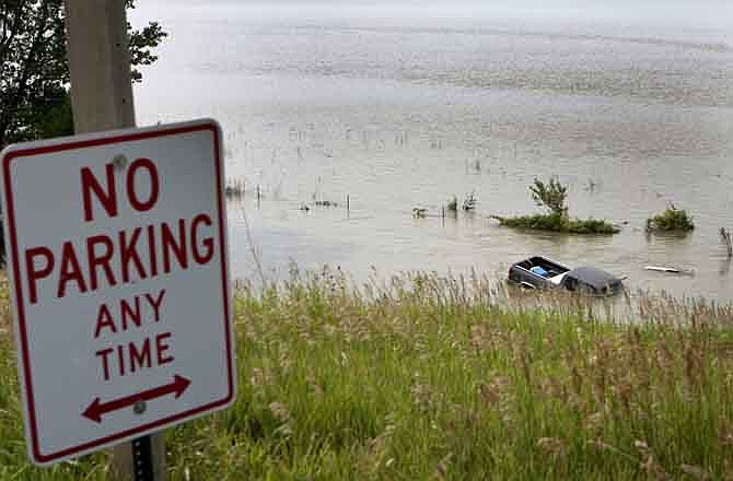 A pickup truck is trapped in floodwaters from the rising Missouri River, along highway 30 south of Modale, Iowa, Monday, July 11, 2011. With the river near historic flood levels, South Dakota Gov. Dennis Daugaard said Monday he believes all Missouri River states can find a way to work together on river issues.