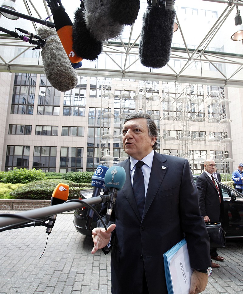 European Commission President Jose Manuel Barroso speaks with the media Thursday as he arrives for an EU summit of eurogroup members at the EU Council building in Brussels.