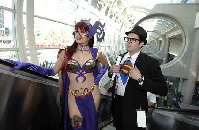 Tracy Ho and Demir Oral pose as they ride the escalator during Preview Night at the Comic-Con 2011 convention Wednesday, July 20, 2011 in San Diego.