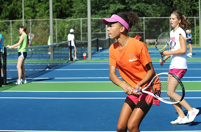 Eden Hoogveld watches her return during Thursday's session of the Jefferson City tennis camp at Washington Park.