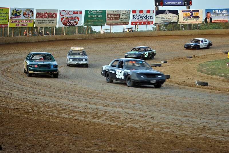 The Cole County Sheriff's Department vehicle, left, edges closer during the warm-up lap, with the Morgan County Sheriff's Department vehicle also feeling out its speed not too far behind (with top lights).