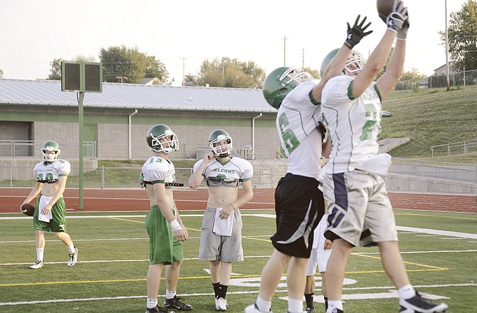 Blair Oaks players run through catching drills during the Falcons football camp in Wardsville. 