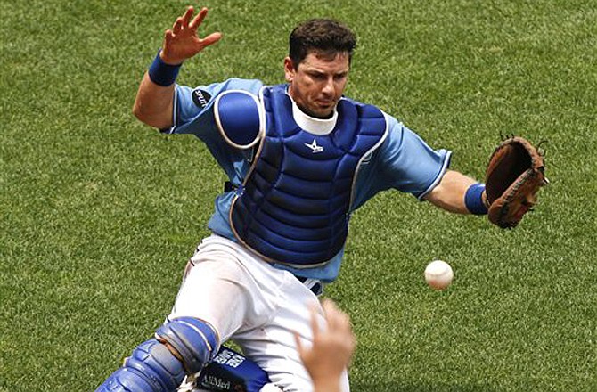 Royals catcher Matt Treanor reaches out but can't catch a foul ball in the third inning of Sunday's game against the Rays in Kansas City.