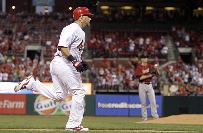 Yadier Molina of the Cardinals rounds the bases after hitting a solo home run in the fourth inning of Monday night's game against the Astros at Busch Stadium.