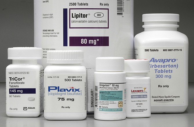 Bottles of prescription drugs as labeled Lipitor, TriCor, Plavix, Singulair, Lexapro and Avapro are displayed at Medco Health Solutions Inc., in Willingboro, N.J. The cost of prescription medicines used by millions of people every day is about to plummet. The next 15 months will bring generic versions of seven of the world's 20 best-selling drugs, including the top two: cholesterol fighter Lipitor and blood thinner Plavix.