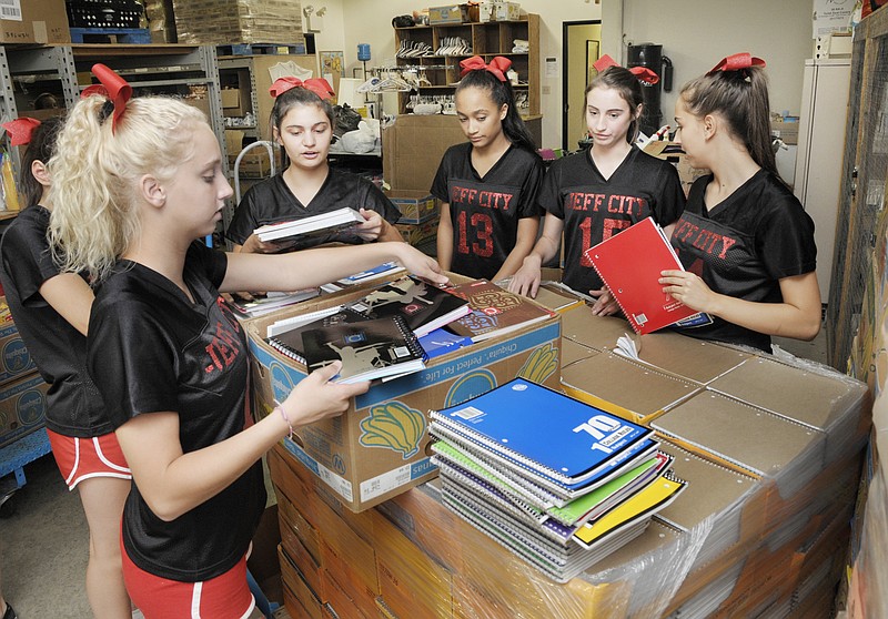 The Jefferson City Jays Cheerleading squad volunteered Tuesday at the Samaritan Center to help sort school supplies.
