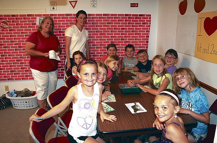 Youth in the class for second and third graders at the Corticelli Baptist VBS work on "walking through the zoo" during bible study. Teachers of the class, standing behind, from left, are Pam Sandidge and Abby Hansen.