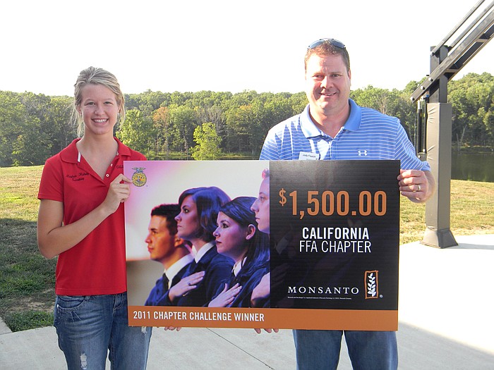 Monsanto Company Territory Sales Manager Jody Foutch, left, presents California FFA President Meghan Halsey with the $1,500 FFA Chapter Challenge Award which the California FFA Chapter won at a FFA meeting held Tuesday, July 19.