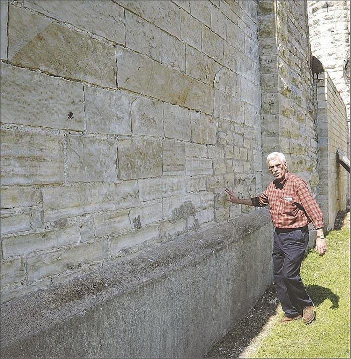 Charlie Brzuchalski points out one of the oldest sections of the walls at the Missouri State Penitentiary.