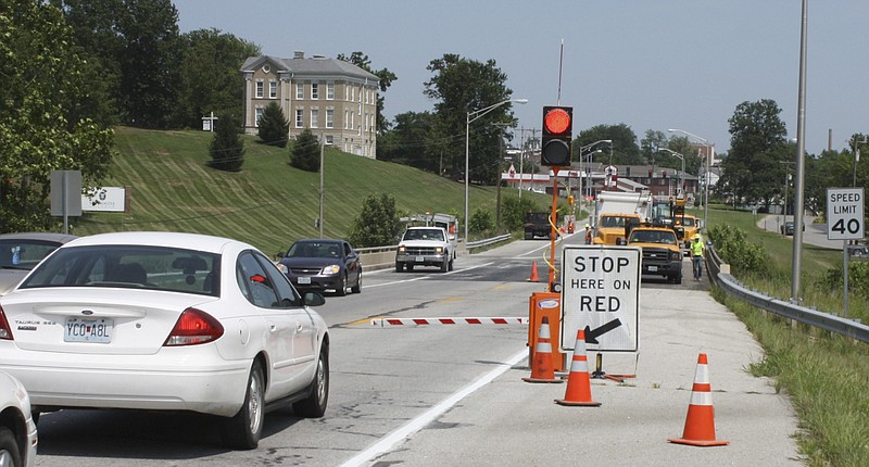 A Missouri Department of Transportation automated flagman signal stops traffic Wednesday on Route F just west of Westminster Avenue in Fulton during bridge deck repairs. Chuck Sullivan, Central District resident engineer, said the automated signals have been in use for about three years.