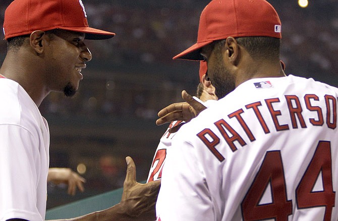 Cardinals pitcher Edwin Jackson (left) shakes hands with teammate Corey Patterson as Jackson arrives to Wednesday's game against the Astros in St. Louis. Jackson and Patterson both came to the Cardinals on as part of a three-team trade between the Cardinals, the Blue Jays and the White Sox.