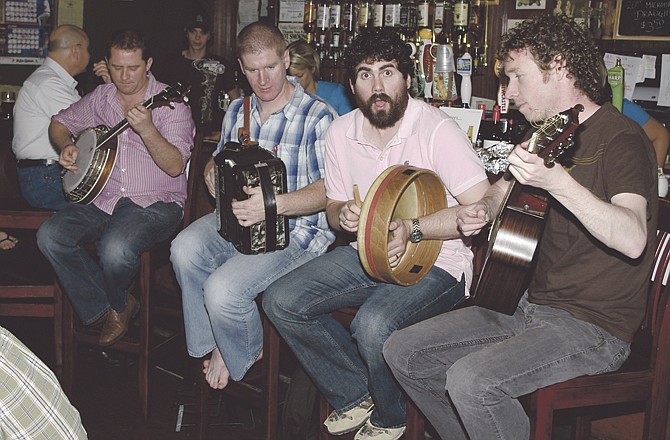 The Fuchsia band plays on the bar during a previous visit to Paddy Malone's in Jefferson City. The Tatmans, owners of the bar, met the band for the first time in 2005. 