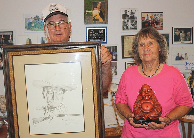 Dean and Mary Lamons, of Fulton, show the items they brought to the Antiques Appraisal fundraiser for the Fulton Presbyterian Manor on Thursday.
