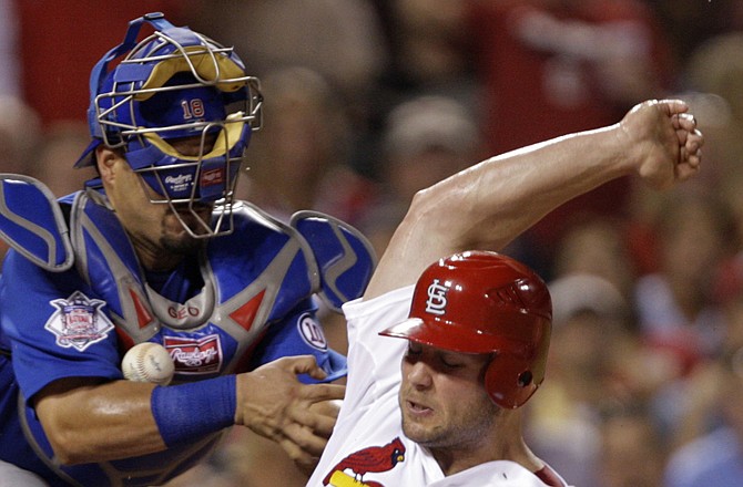 Matt Holliday of the Cardinals scores from second on a single by Yadier Molina as Cubs catcher Geovany Soto can't control the ball during the sixth inning of Friday's game in St. Louis.