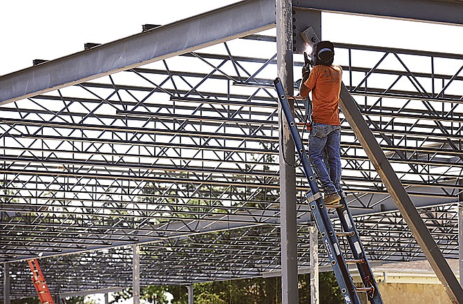 
Marvin Olive, an employee of D&M Steel Erectors, welds a piece of the support structure on the new elementary school at Immanuel Lutheran School in Honey Creek. The school is undergoing its first expansion in more than 30 years.