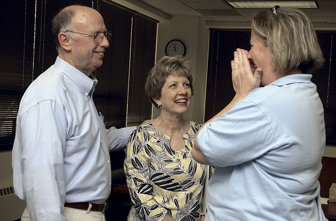 Karen Jennings, right, becomes emotional as she says "goodbye" to Charlie Lansford, at left, during a retirement party in honor of him in city hall. Jennings is director of the Jefferson City Animal Shelter and has worked closely with Lansford in preliminary phases of a new animal shelter. In the middle is Charlie's wife, Barbara Lansford.