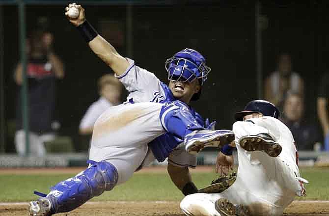 Cleveland Indians' Lonnie Chisenhall, right, is safe at home plate after scoring against Kansas City Royals catcher Brayan Pena in the eighth inning in a baseball game, Saturday, July 30, 2011, in Cleveland. Chisenhall scored on a single by Michael Brantley. Brantley advanced to second on the throw.