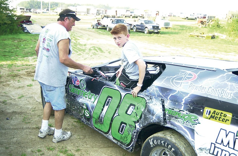 Jake Griffin exits his car following a warm-up run for a race on July 15 at Callaway Raceways. Griffin, 12, is a frequent competitor at the track and is one of many younger drivers to participate in the weekly dirt track drives and frequently goes against drivers significantly older than him. 
