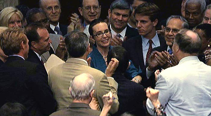 In this image from House Television, Rep. Gabrielle Giffords, D-Ariz., center, appears on the floor of the House of Representatives Monday, Aug. 1, 2011, in Washington. Giffords was on the floor for the first time since her shooting earlier this year, attending a vote on the debt standoff compromise.
