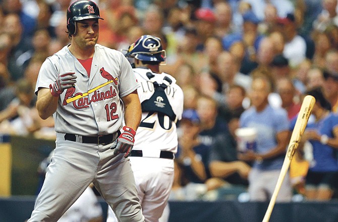 St. Louis Cardinals' Lance Berkman tosses his bat after striking out during the third inning of a baseball game against the Milwaukee Brewers Monday, Aug. 1, 2011, in Milwaukee.