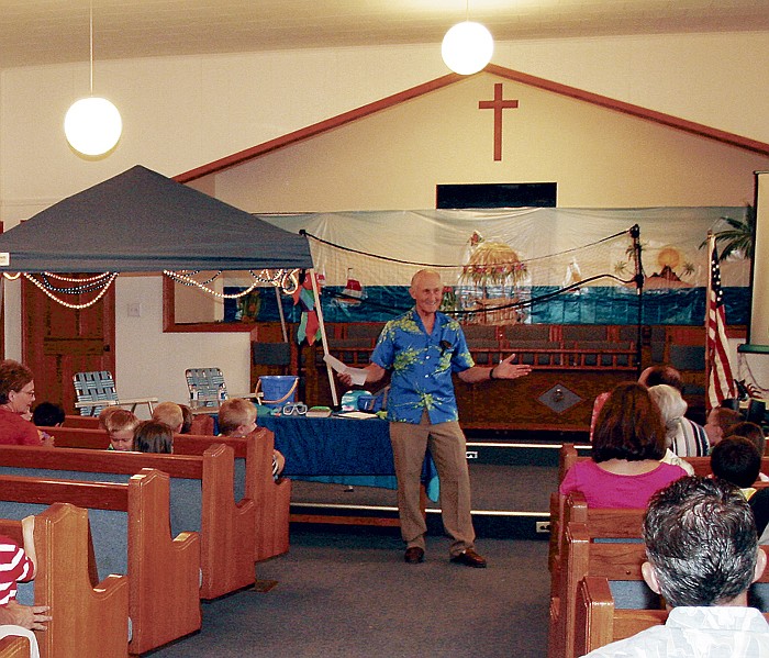 Before leading Vacation Bible School participants in song Friday night at Jamestown Baptist Church, Pastor Louie Moyers asks, "Am I wearing the right shirt?" Moyers wanted the assurance of VBS participants that he had dressed in accordance with the theme for the week, 'Beach Blast'.