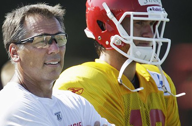 Chiefs quarterback coach Jim Zorn watches practice next to quarterback Ricky Stanzi during training camp Monday in St. Joseph.