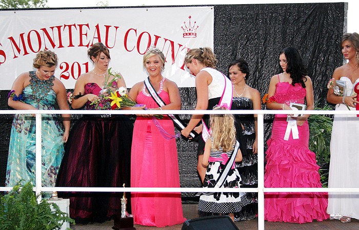 At center, Bailey Glenn, daughter of Steve and Kristie Glenn, California, is crowned the 2011 Miss Moniteau County Queen by 2010 Miss Moniteau County Queen Tabatha Hoback Tuesday, Aug. 2, at the main arena of the Moniteau County Fairgrounds. Assisting Hoback is the newly crowned 2011 Little Miss Moniteau County Kierstyn Lawson, 5. Remaining 2011 Miss Moniteau County candidates, from left, are Pax Baker, Kirstyn Roush, Amy Masterson, Kelsey Parrott-Kuhn and Kassi Meisenheimer. 