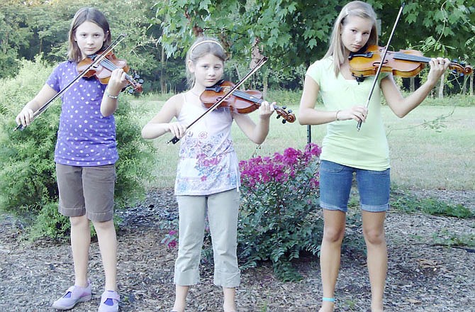 From left, Carlie, Sophia and Olivia Cunningham have been playing the fiddle - and competing - for several years. The sisters will be participating Saturday night in the youth division of the Fiddlers Contest at the Callaway County Fair.