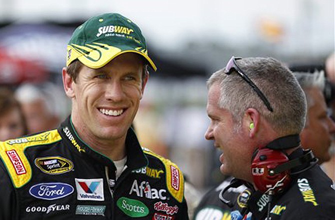 Carl Edwards, shown here standing with crew chief Bob Osborne earlier this year at Daytona International Speedway, has signed a multi-year extension to stay with Roush Fenway Racing.