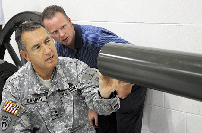 Charles Machon, director of the Museum of Missouri Military History, and Adjutant Gen. Steve Danner look at the engraving on one of the museum's recent acquisitions. This is an 1890s-type cannon used by a St. Louis unit during the Spanish-American War. It had been housed at the now-closed Kemper Military School in Boonville.