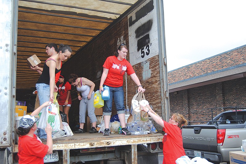 The Fulton Jaycees unload supplies to a shelter in Joplin May 28. Members in the photo are Brenna Meyer, Ashton Meyer, Morgan McGrath, Jessica Cozad, Raylea Meyer and Martha McGrath. With the help of several groups, businesses and the community, Together for Joplin gathered and delivered donations to tornado-struck Joplin. 