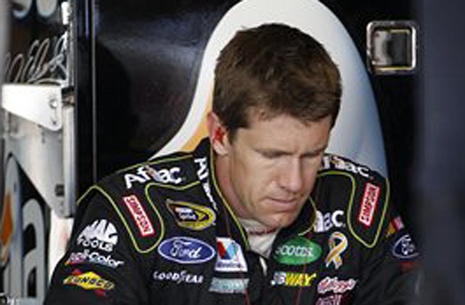 Carl Edwards sits in the garage during a practice session Friday for Sunday's Sprint Cup race in Long Pond, Pa.