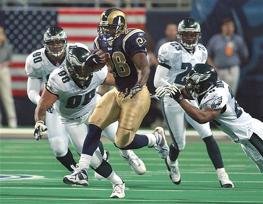AP
Rams running back Marshall Faulk weaves his way through several Eagles defenders during the NFC Championship game Jan. 27, 2002, in St. Louis.