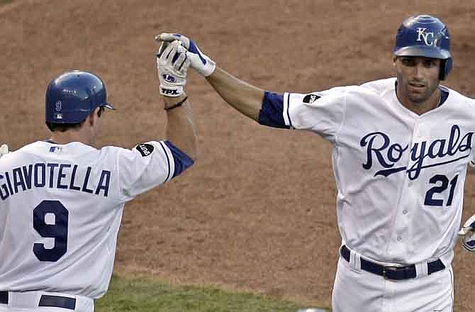 Kansas City Royals' Jeff Francoeur (21) celebrates with teammate Johnny Giavotella (9) after hitting a solo home run during the fifth inning of a baseball game against the Detroit Tigers, Saturday, Aug. 6, 2011, in Kansas City, Mo. 