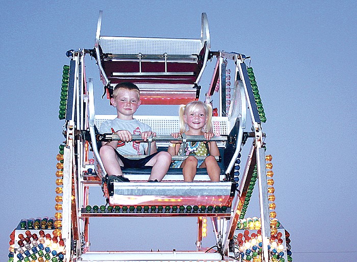 In this August 2011 photo, youngsters ride a Ferris wheel at the Moniteau County Fair. 