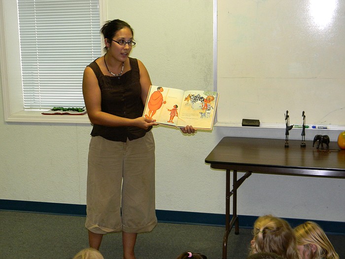 Margaret Fennewald reads "Papa, Do You Love Me," a story about the Masai Tribe which resides in Kenya and Tanzania, during the Summer Reading Program held Thursday, Aug. 4.