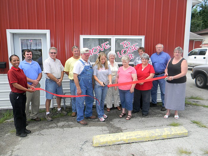 Members of the California Area Chamber of Commerce, family and friends help Move It To Lose It Owner Brooke Pace cut the ribbon on her new business.