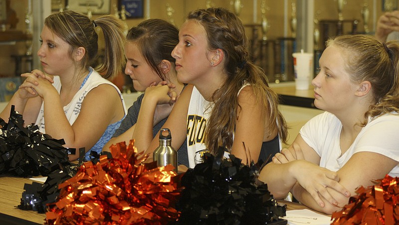 Cheerleaders listening intently to a state expert explain Internet safety at New Bloomfield High School Tuesday night are, from left, Alexis Smith, Keaira Ruppel, Nicole Dawson, and Ashlie Emerson.