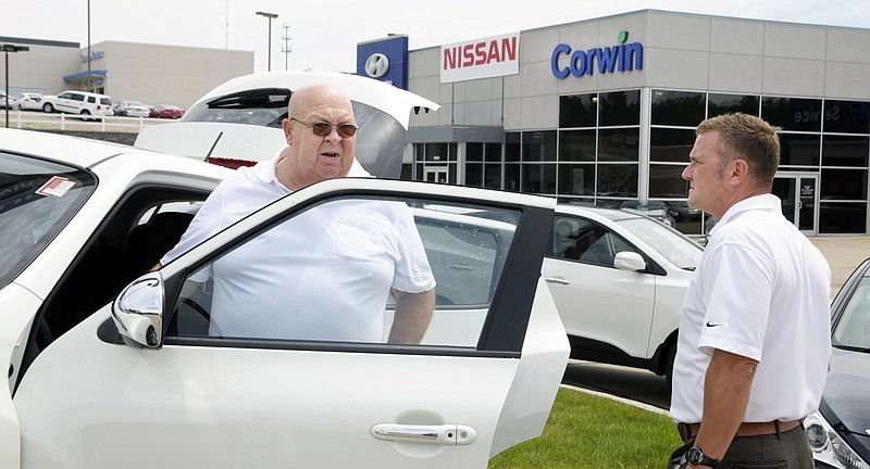 Corwin Nissan salesman, Mark Maher, right, shows a Nissan Juke to customer Charles Dingley from Belle. Corwin Hyundai recently purchased the Nissan franchise from Capitol City Chrysler and moved the inventory to their lot.