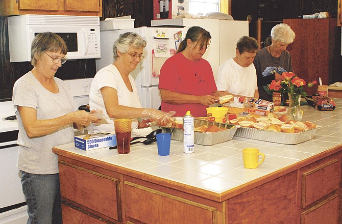 From left, Helen Manson, Luella Randolph, Mary Steck, Marlee Green and Janet Nichols work together to prepare part of the meals they will serve out of the newly renovated kitchen at the Holts Summit Civic Center, where volunteers have a soup kitchen and serve a meal twice a week. 
